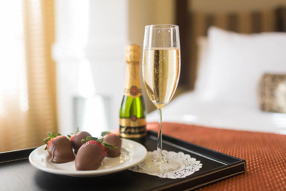 Champagne and chocolate-covered strawberries in room